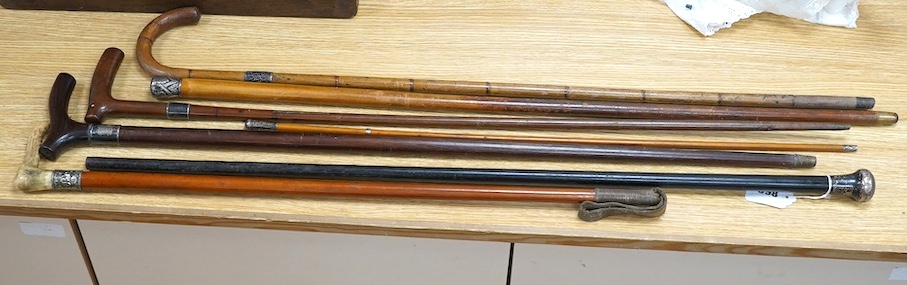 Four mixed silver mounted walking sticks, a riding crop and a baton, longest 88cm. (6). Condition - fair considering use and age